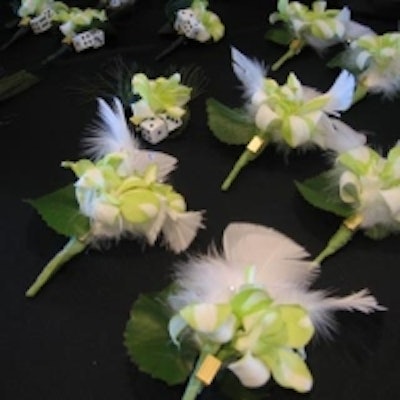 Guests received boutonnières made of feathers, florals, and mini gambling dice accents at the Risk Management Council of Canada's annual gala, held in Next Level at the Docks Entertainment Complex.