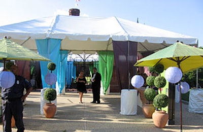 A reception tent in front of the Enid A. Haupt garden.