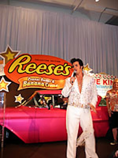 An Elvis impersonator posed with a pink Cadillac at the Reese's promotion.