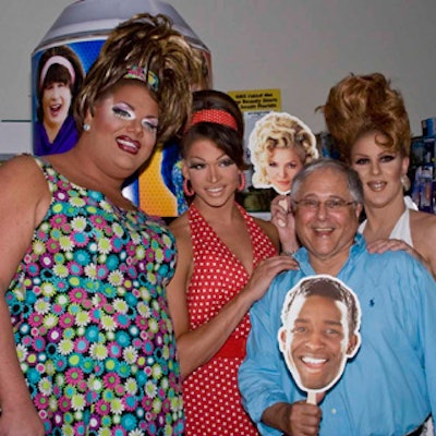 Event entertainers—drag queens Misty Eyez, Rebecca Glasscock, and Franchesqua Richards—pose with GBS founder Ken Bern, as he toys with a Seaweed J. Stubbs mask.