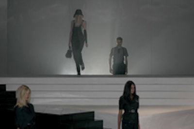 In addition to the side entrances, some models emerged from behind a smoky black-and-white backdrop.