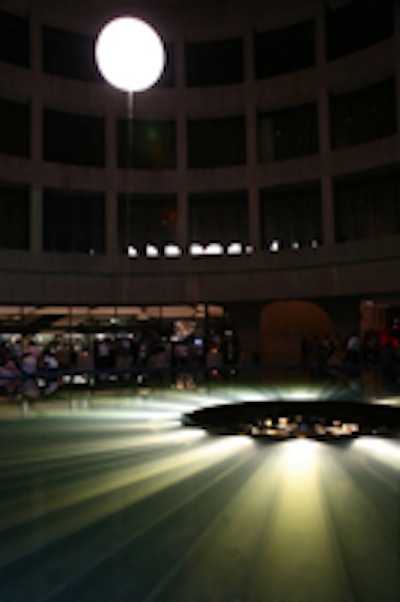 A six-foot glowing moon ballon hung above the fountain in the Hirshhorn plaza, creating a shadowy atmosphere.