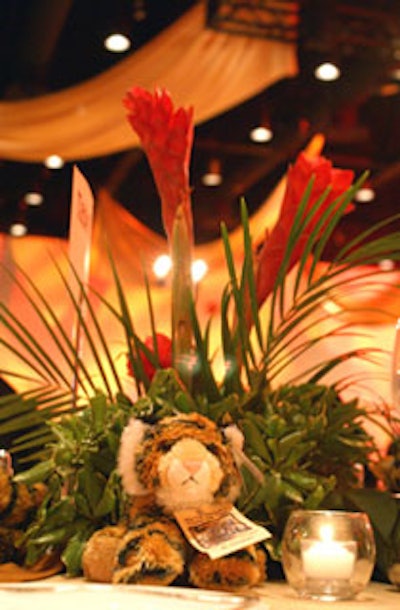 Each of the 58 tables was draped in various animal-print linens and featured tropical centerpieces of coral anthuriums and torch red ginger.