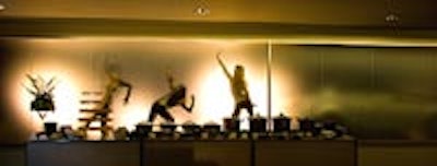 Dancers performed in silhouette behind a frosted glass wall at BMW Toronto Headquarters for the automaker's annual charity casino night.