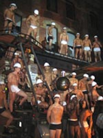 Models wearing little more than hard hats and skivvies posed on a truck with steel scaffolding at the entrance to Brant House during the Calvin Klein Underwear 25th Anniversary Party.