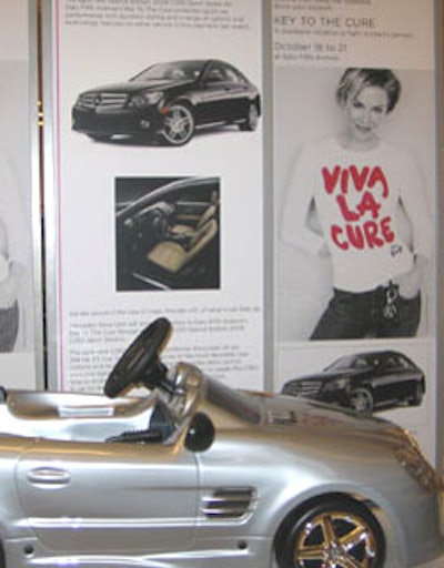 A mini model of a Mercedes—the carmaker is a partner in the Key to the Cure campaign—was part of a display featuring the 'Viva La Cure ' campaign posters and a full-size Mercedes.