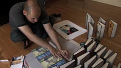 Artist Someguy cuts a journal cover in Andrea Kreuzhage's documentary 1,000 Journals.