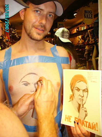 An artist from Second Skin Miami created an airbrushed portrait for an excited guest.