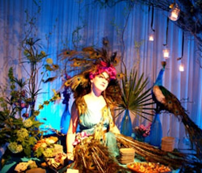 A peacock-dressed model lounged on one of the tables holding gourmet treats from Mise en Place.