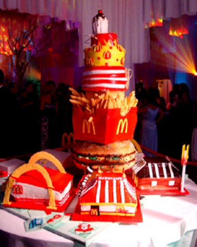 Fondant replicas of five Tampa McDonald's restaurants surrounded the first tier of the 50th birthday cake with a signature hot fudge sundae as a cake topper.