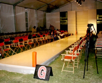 The runway was set up on a grassy area with goalposts on both ends and director's chairs of orange and black lining each side.