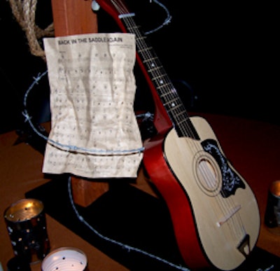 A guitar wrapped in barb wire and the sheet music to 'Back in the Saddle Again ' conveyed the evening's theme.