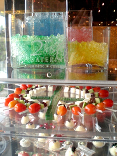 2Taste Catering provided colorful gel displays along with its hors d 'oeuvres such as the tomato, cucumber, olive, and mozzarella skewers.