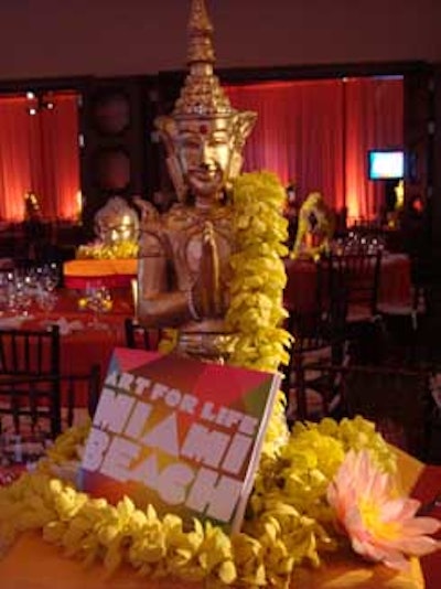 Each of the centerpieces in the dining area featured a different Eastern-themed statue and exotic flowers.