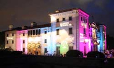 Sponsors ' logos were projected onto the exterior walls of the mansion.