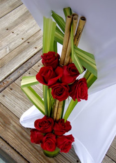 The Flower Bar created striking floral arrangements of bright red roses, bamboo, and palm leaves.