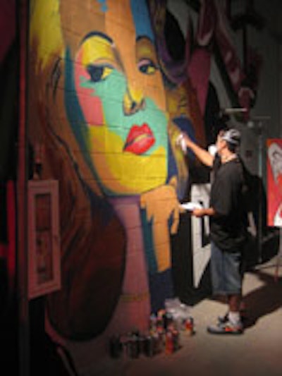 A muralist at Angeleno magazine's summer release party.