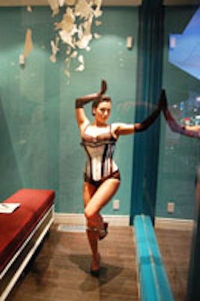 A burlesque dancer at the Secrets From Your Sister opening