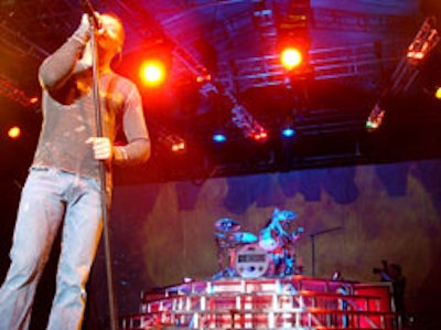 A large projection screen showing images of various natural elements like fire, stars, and lightening—accompanied by matched lighting changes—served as the backdrop for 3 Doors Down's performance at Bud Bowl.