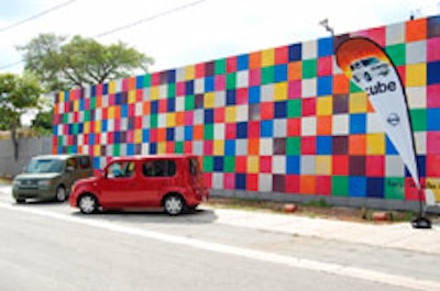 Two Cubes in front of the venue's mural