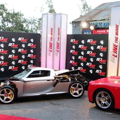 A totaled car displayed outside for a movie premiere