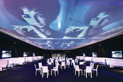 A scrim hanging overhead showed a kinetic display of still images under the tent at the opening night party for the Annenberg Space for Photography in Los Angeles.