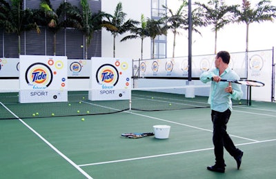 A guest practicing his serve at Tide's branded tennis court