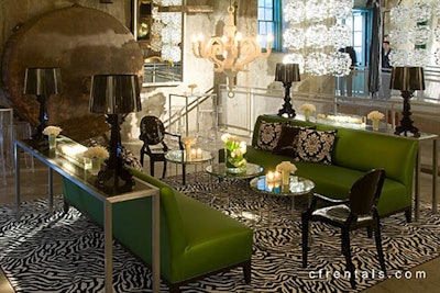 Kelly green sofas, white Moooi chandelier, black Bourgie lamps, black Louis Ghost chairs, glass-and-chrome coffee tables on zebra carpeting