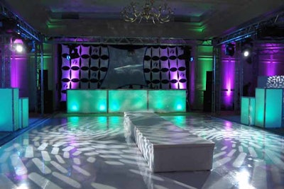 Rock ’n’ roll ballroom treatment. Custom dance floor treatment, intelligent lighting, color-changing LED room wash video projections and illuminated bars.