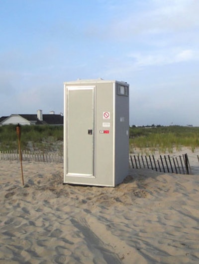 Solar-powered portable restroom with sink on the beach