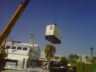 Generator being craned onto a yacht