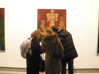 Gallery-goers admiring a work