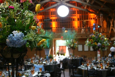 Private dinner in a barn with exquisite florals and alternative band on balcony