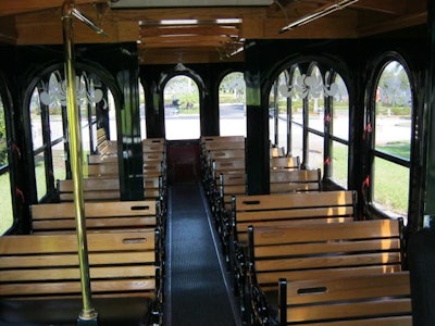 Interior of Trolley: Brass Rails, Oak Wood, and Padded Seats