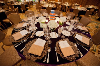 Select Event Rentals draped the dinner tables in dark purple velvet topped with white hydrangea centerpieces.