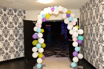 An arch of pastel-colored balloons framed the entrance to the ballroom.