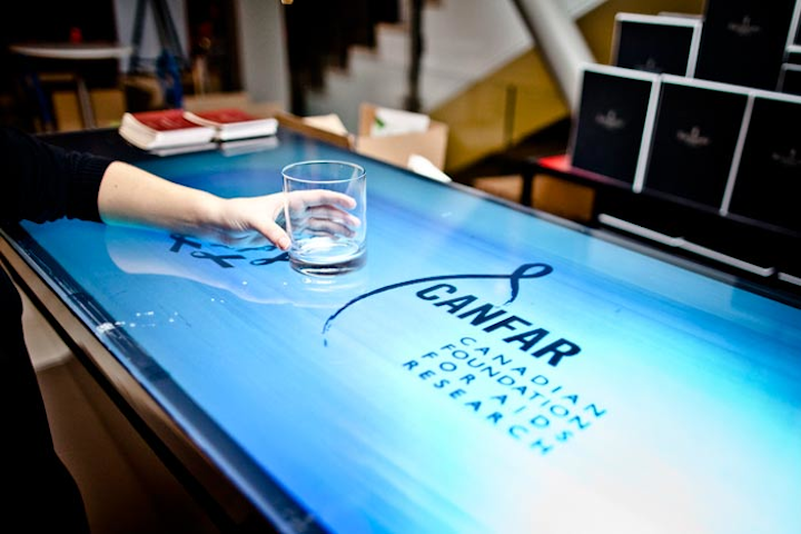 Imagin8 supplied an interactive bar. When guests moved over the bar, the screen would display moving sponsor logos or the Canfar red ribbon.
