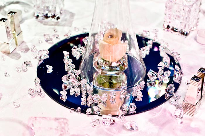 Crystals were scattered at the base of the rose floral centrepiece on the tables. A bejeweled rose sat in a small crystal votive inside the glass vase.