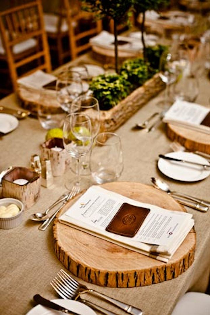 The Roots dining room had an outdoorsy feel, with wood charger plates, live plant centrepieces, and leather card-holder as a gift for guests.
