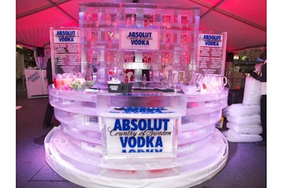 Iceculture created the circular branded ice bar. Absolut bottles decorated the ice wall. The holiday cocktail menu was engraved in ice blocks on both sides of the bar.