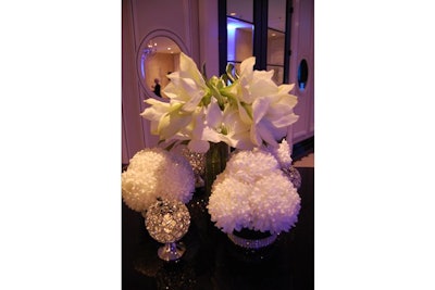 White flower arrangements added to the simple decor in the cocktail area outside the Regency Ballroom.