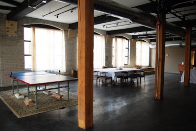 On the third floor, windows are draped and the ceiling is painted black. Exposed brick and beams give the space a raw feel. New flooring and chandeliers will be added in the coming months.