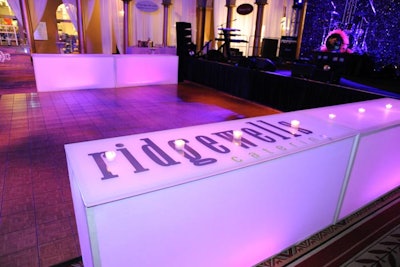 At Club Breath, the dance floor was flanked by two glowing purple tables branded with the Ridgewells Catering logo.
