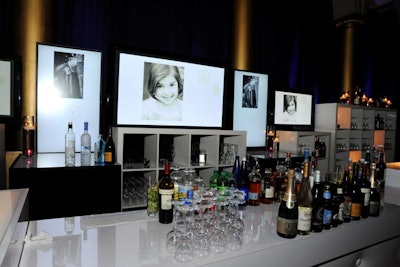A sponsor loop interspersed with photos of cystic fibrosis patients played on flat screens behind a bar during the reception.