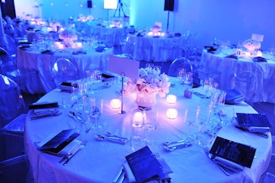 Clear ghost chairs and white tablecloths created clean lines in the V.I.P. dining room. Seventy-five cymbidium orchids made up the centrepiece at each table, mimicking the circular balloons overhead.