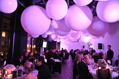 Hundreds of balloons from Balloon Trix hung from the ceiling during the V.I.P. dinner. The space changed colour with each course, starting with blue, morphing to pink for the main course, changing to orange for dessert, and ending in red.