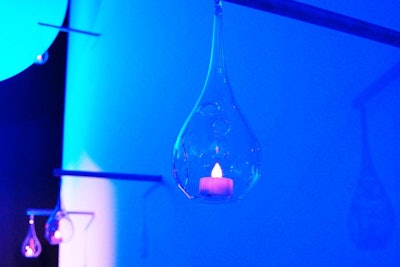 Glass votives with electric candles hung from the ceiling in the V.I.P. dining room.