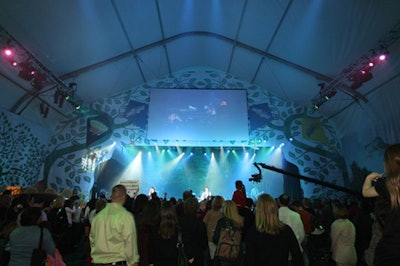 The stage backdrop featured images of trees.