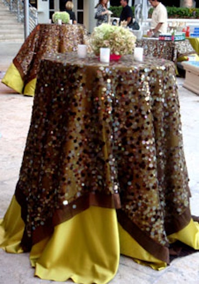 Nuage Designs draped the cocktail tables in lime green linens with a sheer brown, sequined overlay and topped them with small, compact arrangements of green hydrangeas.