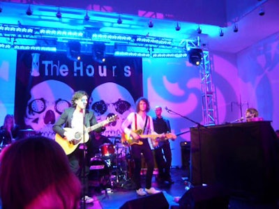 The band the Hours performed from a stage washed with blue and purple lighting.